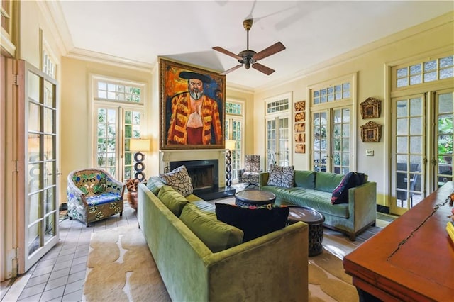 living room with ornamental molding, light tile patterned floors, ceiling fan, and french doors