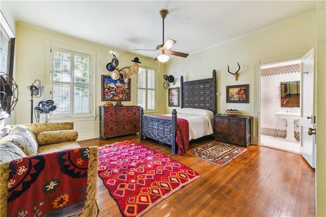 bedroom with hardwood / wood-style floors, ornamental molding, ceiling fan, and ensuite bathroom