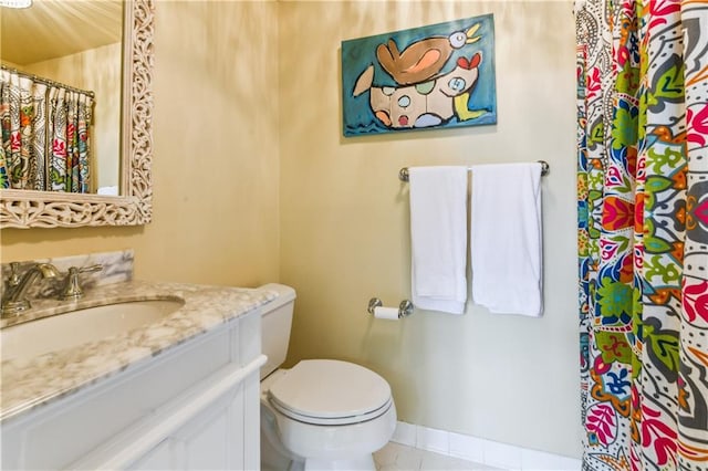 bathroom featuring vanity, tile patterned floors, and toilet