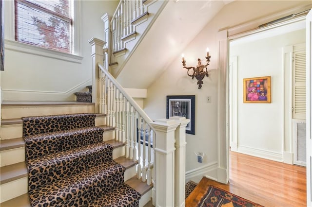 stairway with hardwood / wood-style flooring