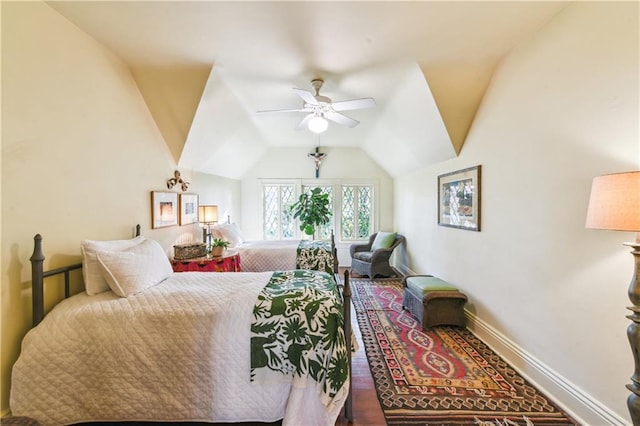 bedroom with ceiling fan, lofted ceiling, and hardwood / wood-style floors