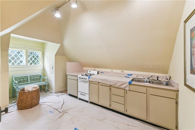 bathroom featuring vaulted ceiling, track lighting, and sink