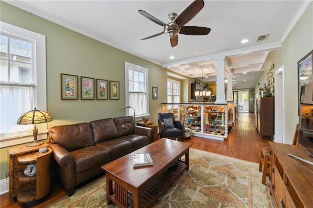 living room featuring coffered ceiling, ornate columns, crown molding, beamed ceiling, and hardwood / wood-style floors