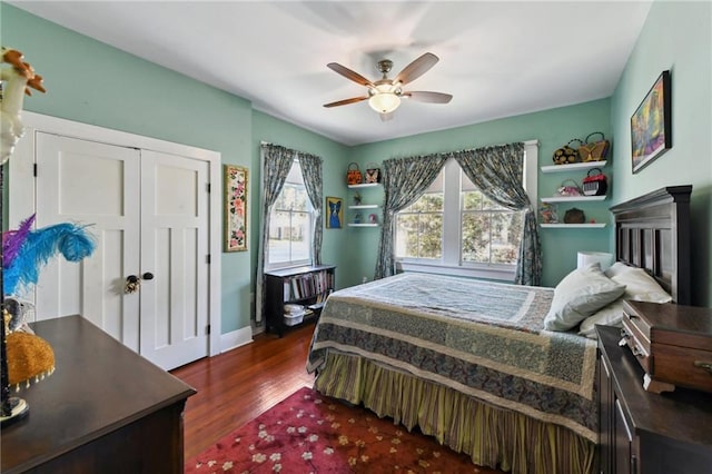 bedroom with dark hardwood / wood-style floors and ceiling fan