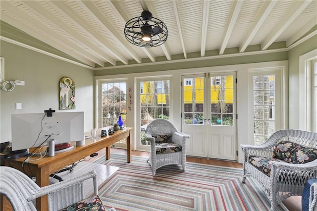 sunroom / solarium featuring beamed ceiling