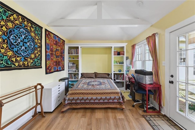 living area featuring vaulted ceiling with beams and light hardwood / wood-style floors