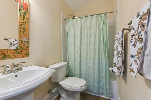 full bathroom with sink, hardwood / wood-style flooring, shower / tub combo, vaulted ceiling, and toilet