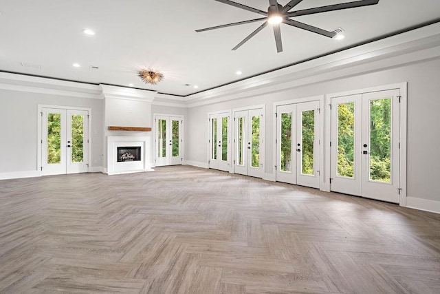 unfurnished living room with french doors, light parquet flooring, ornamental molding, and ceiling fan