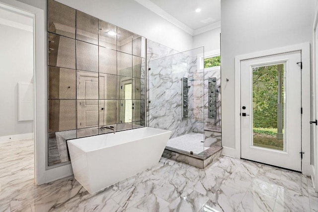 bathroom featuring ornamental molding and separate shower and tub