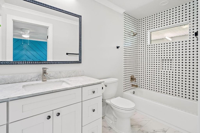 full bathroom with tiled shower / bath, vanity, and toilet