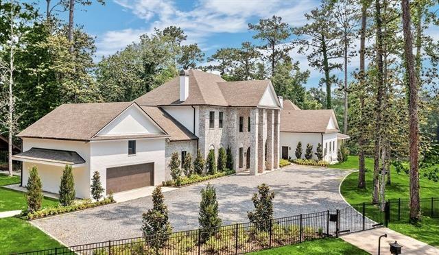 view of front of house featuring a garage and a front lawn