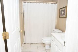 bathroom with tile patterned flooring, vanity, and toilet