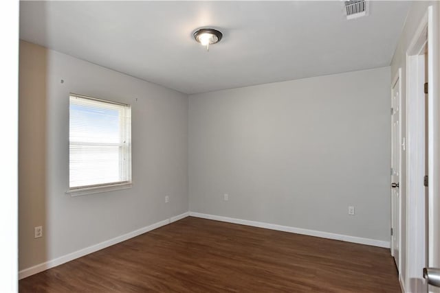 unfurnished room featuring dark wood-type flooring