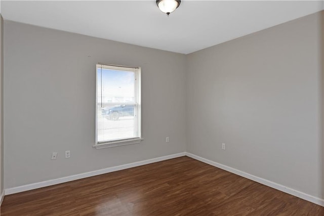 empty room with dark wood-type flooring