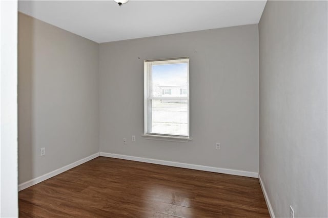 empty room featuring dark hardwood / wood-style flooring