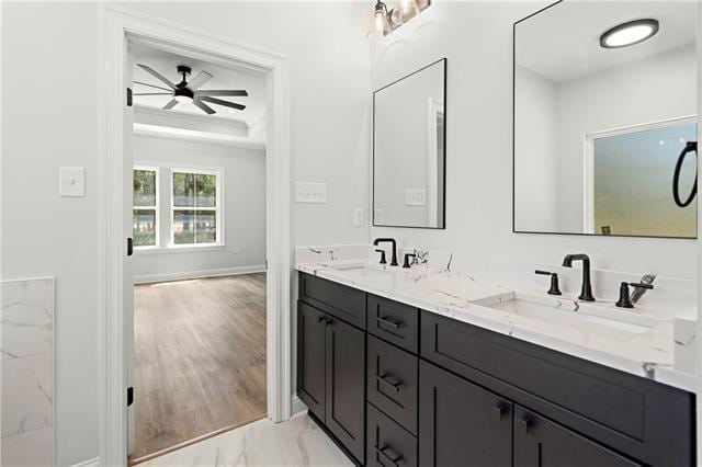 bathroom with vanity, a tray ceiling, and ceiling fan