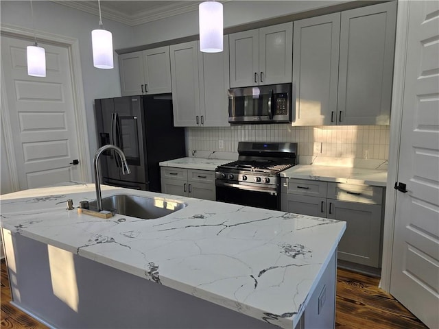 kitchen with sink, appliances with stainless steel finishes, gray cabinetry, light stone countertops, and decorative light fixtures