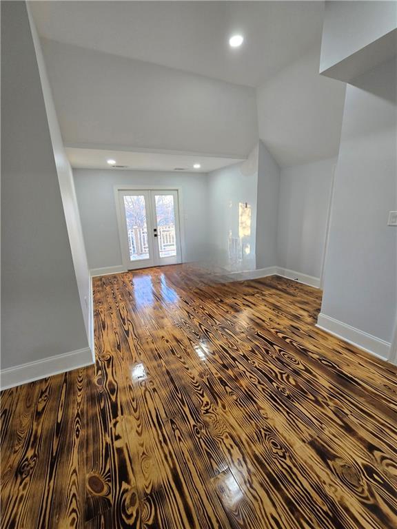 interior space featuring lofted ceiling, hardwood / wood-style floors, and french doors