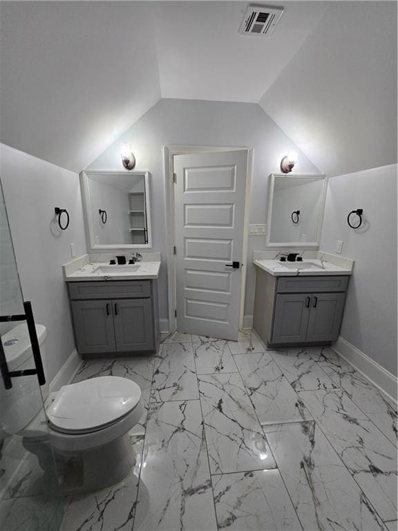 bathroom with vanity, toilet, and vaulted ceiling