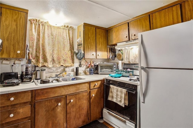 kitchen featuring sink and white appliances