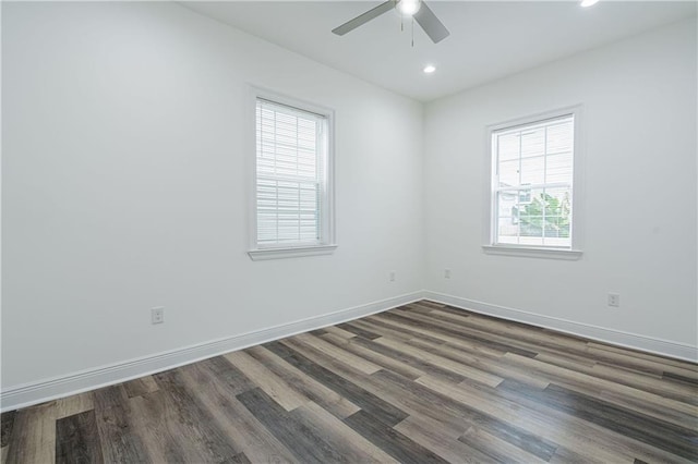 empty room featuring ceiling fan and dark hardwood / wood-style flooring