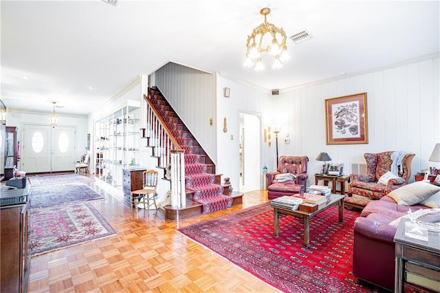 living room with crown molding, parquet floors, and an inviting chandelier