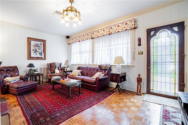 1201 Moss Ln, River Ridge, LA 70123 - living room featuring light parquet flooring, ornamental molding, and a chandelier