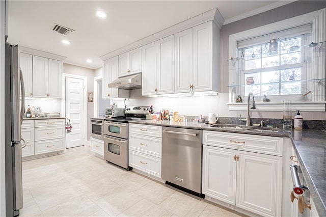 1201 Moss Ln, River Ridge, LA 70123 - kitchen featuring sink, crown molding, stainless steel appliances, white cabinets, and dark stone counters