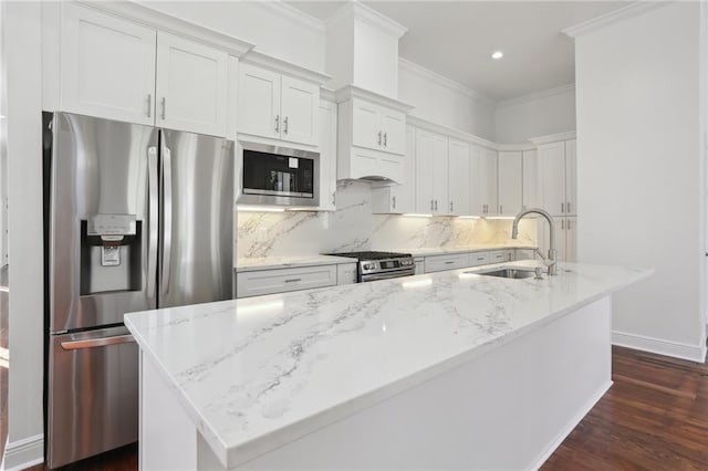 kitchen with tasteful backsplash, ornamental molding, appliances with stainless steel finishes, dark wood-style floors, and a sink