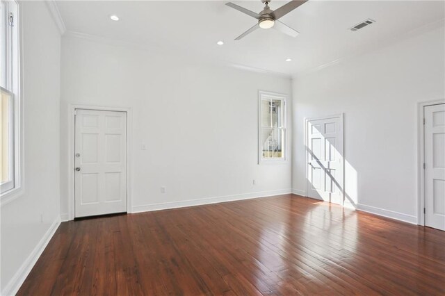 spare room featuring visible vents, baseboards, a ceiling fan, and hardwood / wood-style flooring