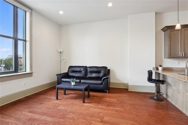 living area featuring sink and dark hardwood / wood-style floors