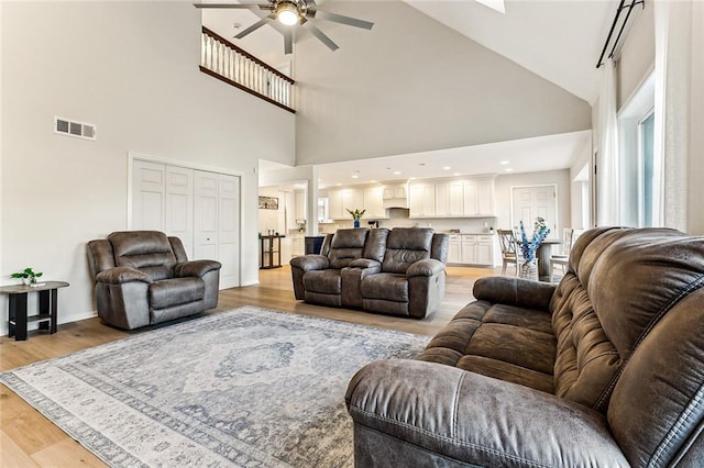 living room with ceiling fan and light wood-type flooring