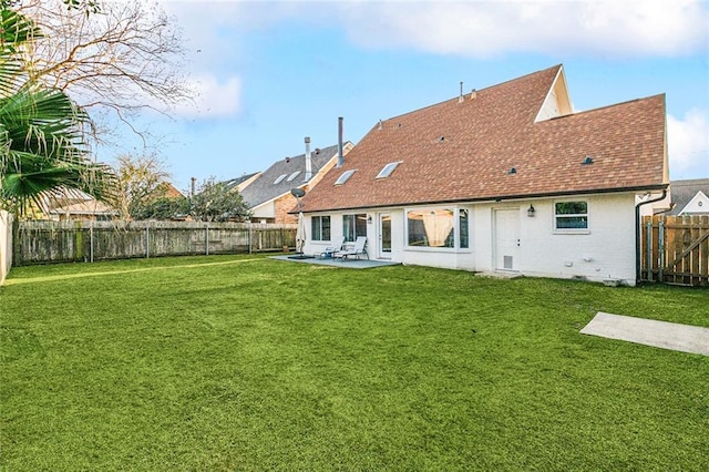 back of house with a patio and a lawn