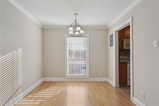 unfurnished dining area featuring crown molding, an inviting chandelier, electric panel, and light hardwood / wood-style floors