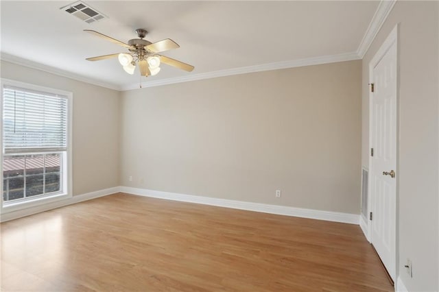 empty room with hardwood / wood-style flooring, ornamental molding, and ceiling fan