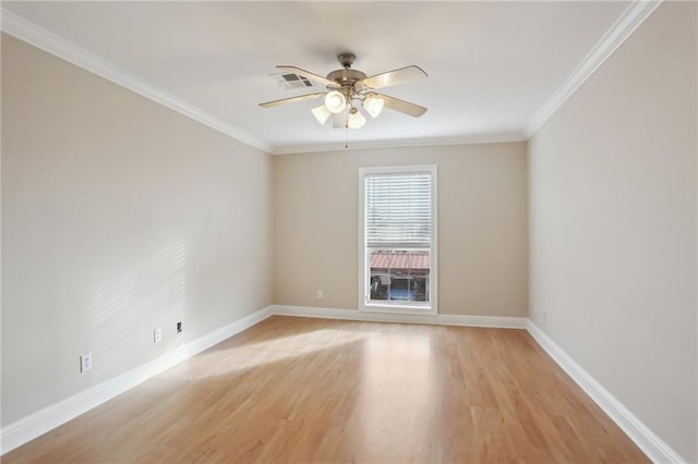 spare room with ornamental molding, ceiling fan, and light hardwood / wood-style floors