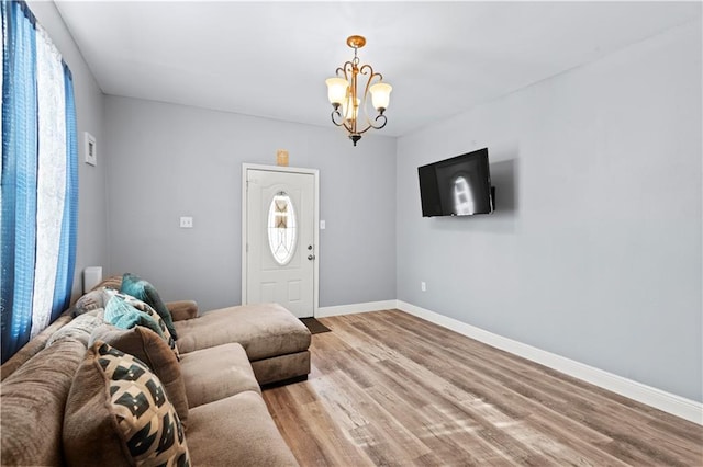 living room featuring an inviting chandelier and light hardwood / wood-style floors