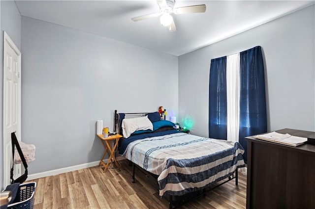 bedroom with ceiling fan and wood-type flooring