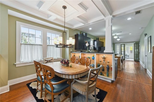 dining space with coffered ceiling, dark hardwood / wood-style flooring, decorative columns, and beamed ceiling