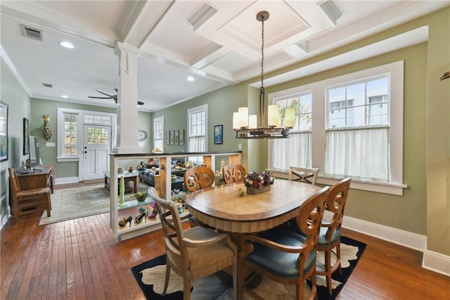 dining space with ornate columns, ceiling fan with notable chandelier, dark hardwood / wood-style flooring, coffered ceiling, and crown molding