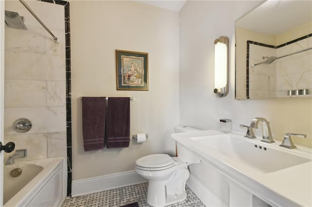 full bathroom with sink, tiled shower / bath combo, and toilet