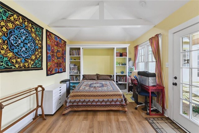 sitting room featuring lofted ceiling with beams and light wood-type flooring