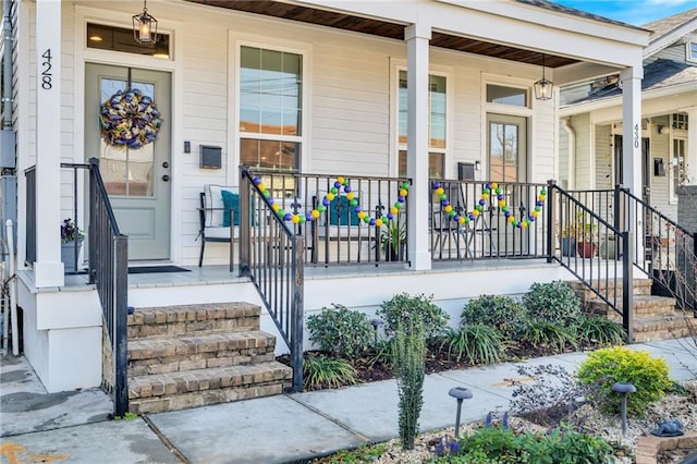 doorway to property featuring covered porch