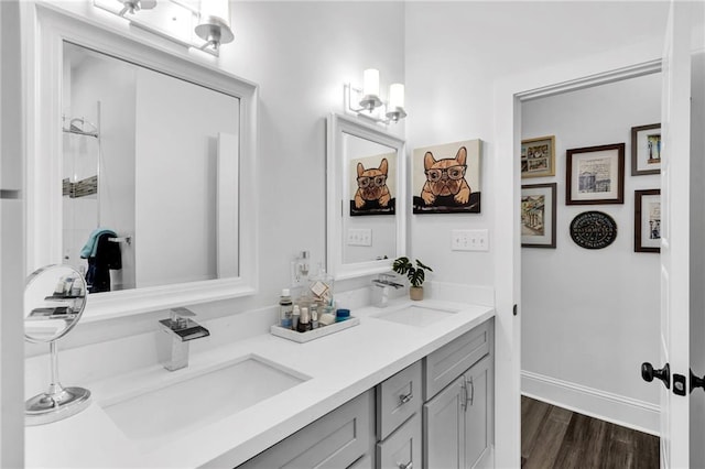 full bathroom with a sink, wood finished floors, and double vanity