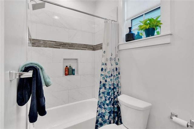 bathroom with shower / tub combo with curtain and toilet