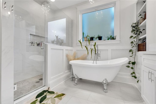 bathroom featuring shower with separate bathtub, vanity, and a chandelier