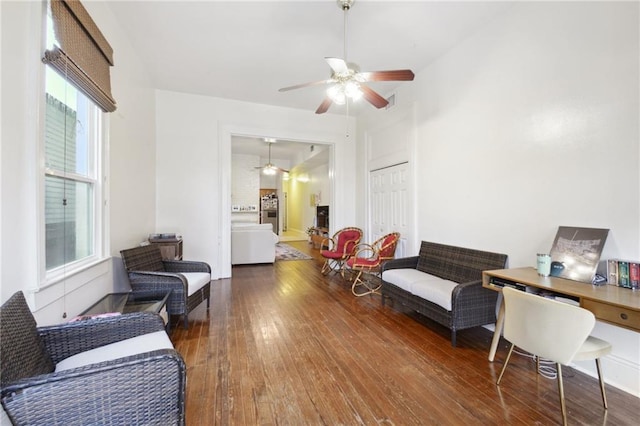 living area featuring ceiling fan and hardwood / wood-style flooring