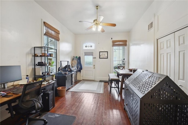 home office featuring hardwood / wood-style flooring, a ceiling fan, visible vents, and a wealth of natural light