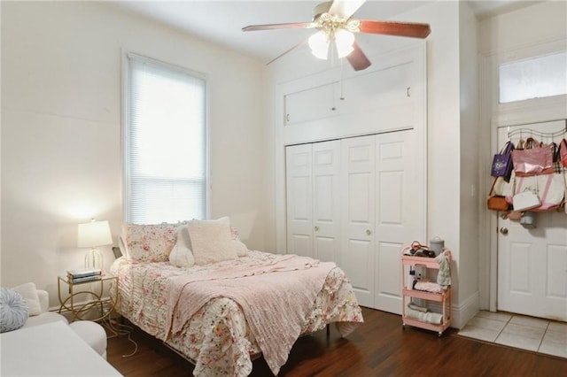 bedroom featuring a closet, a ceiling fan, and wood finished floors