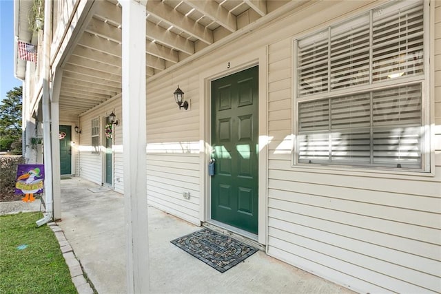 view of exterior entry with a porch